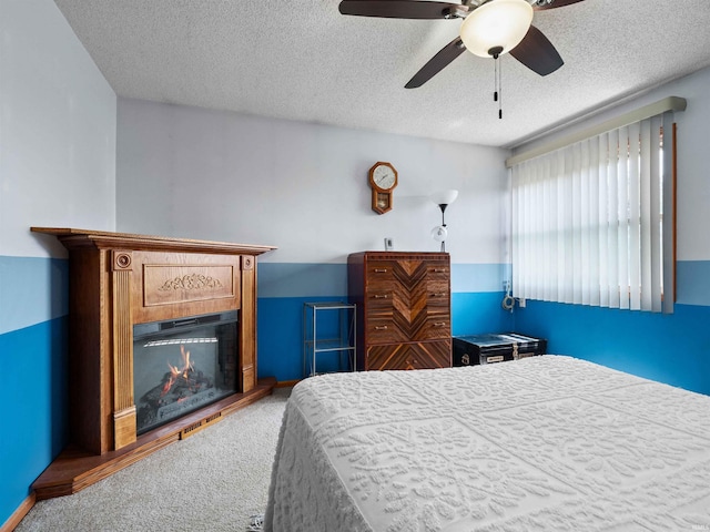 12928 Barley Knob Rd, Grabill, IN 46741 - carpeted bedroom featuring a lit fireplace, a textured ceiling, and ceiling fan