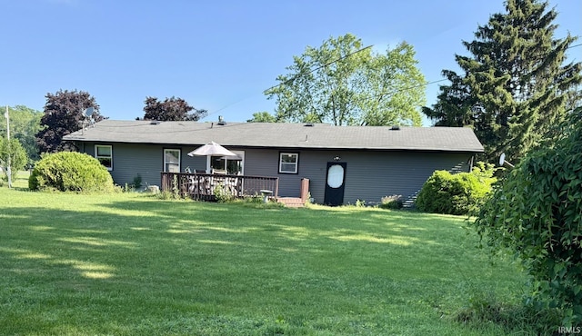 18460 Brewster Dr, Bristol, IN 46507 - back of house featuring a lawn and a deck