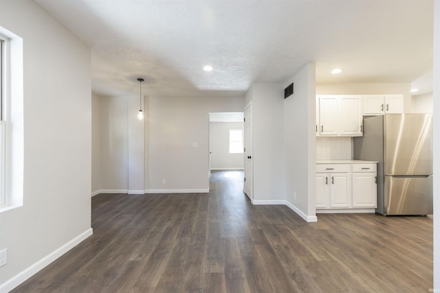 1725 Rainbow Bend Blvd, Elkhart, IN 46514 - kitchen with freestanding refrigerator, white cabinetry, dark wood-style flooring, recessed lighting, and light countertops