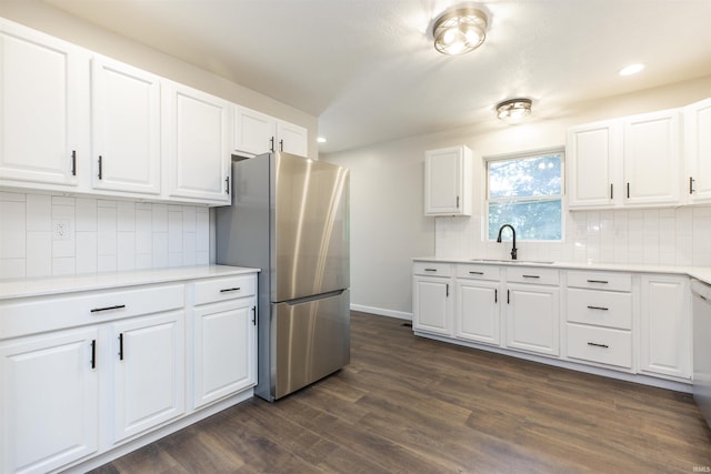 1725 Rainbow Bend Blvd, Elkhart, IN 46514 - kitchen with freestanding refrigerator, dark wood finished floors, tasteful backsplash, white cabinetry, and recessed lighting