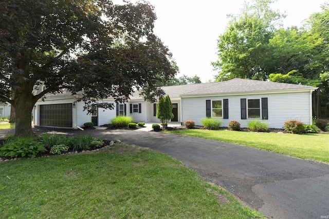 1725 Rainbow Bend Blvd, Elkhart, IN 46514 - view of front facade featuring asphalt driveway, an attached garage, and a front lawn