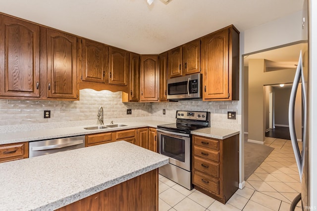 4301 W Friar Dr, Muncie, IN 47304 - kitchen featuring stainless steel appliances, light tile patterned flooring, light countertops, and backsplash