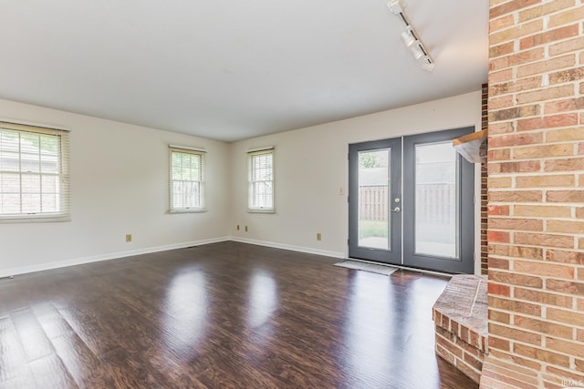 4301 W Friar Dr, Muncie, IN 47304 - unfurnished living room featuring rail lighting and dark wood-style floors