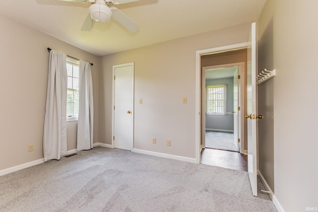 4301 W Friar Dr, Muncie, IN 47304 - unfurnished bedroom featuring carpet floors, multiple windows, and ceiling fan