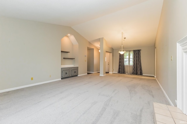 4301 W Friar Dr, Muncie, IN 47304 - unfurnished living room featuring lofted ceiling, light carpet, and built in shelves