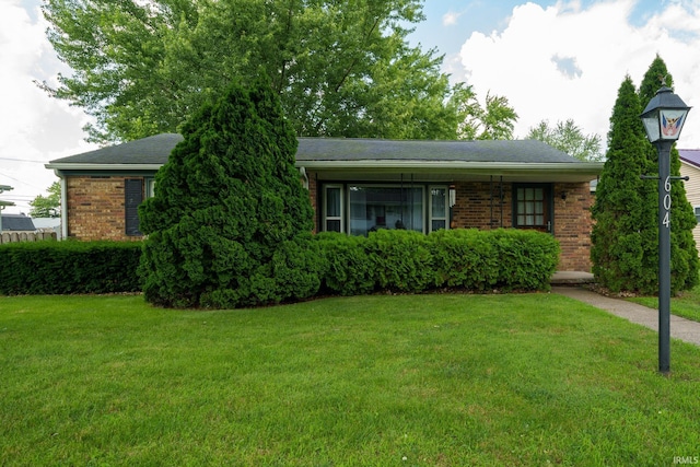 604 W 10th St, Jonesboro, IN 46938 - view of front of property featuring brick siding and a front yard