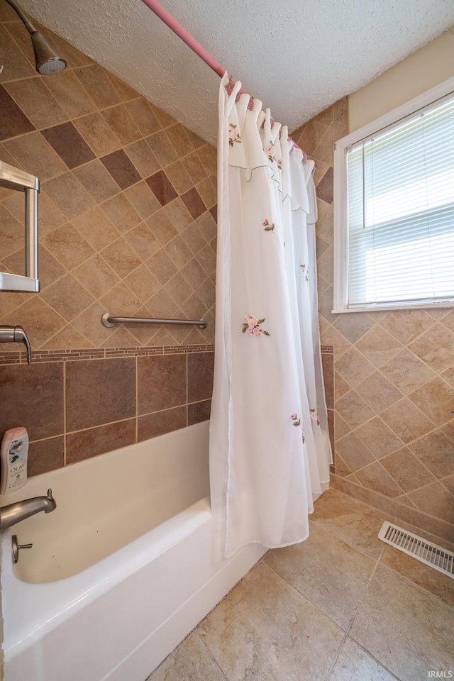 604 W 10th St, Jonesboro, IN 46938 - bathroom with shower / bath combo with shower curtain, tile patterned floors, and a textured ceiling