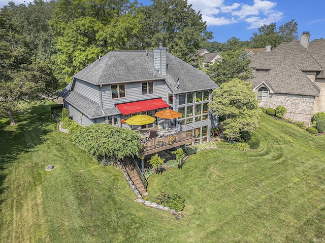 54454 Heron Cove Ln, Elkhart, IN 46516 - back of house with a wooden deck, a chimney, a lawn, and roof with shingles