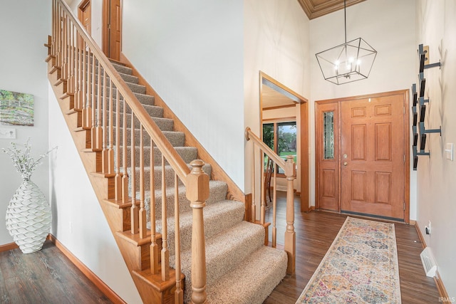 54454 Heron Cove Ln, Elkhart, IN 46516 - foyer entrance featuring dark wood-style flooring, a high ceiling, stairs, and a chandelier
