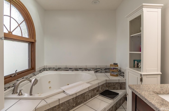 4365 N Maple Grove Rd, Bloomington, IN 47404 - bathroom featuring a whirlpool tub, vanity, and tile patterned floors