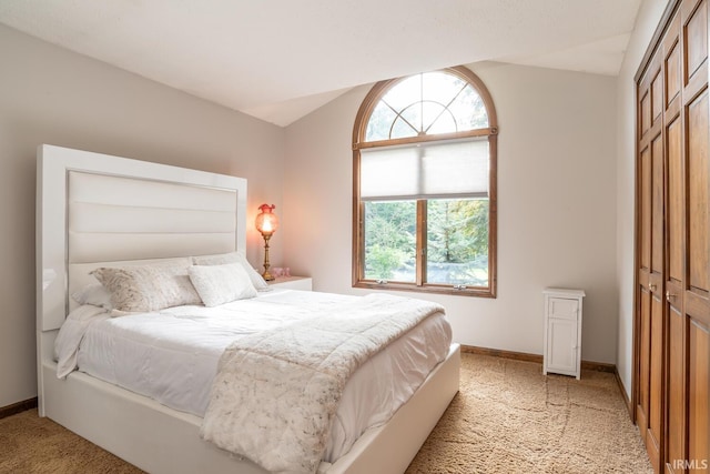 4365 N Maple Grove Rd, Bloomington, IN 47404 - bedroom with light colored carpet, vaulted ceiling, and a closet