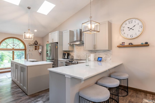 4365 N Maple Grove Rd, Bloomington, IN 47404 - kitchen featuring wall chimney exhaust hood, stainless steel appliances, gray cabinetry, decorative backsplash, and vaulted ceiling