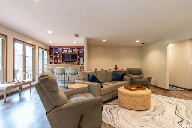 4365 N Maple Grove Rd, Bloomington, IN 47404 - living area featuring wood finished floors, a textured ceiling, and recessed lighting