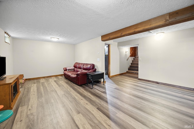 10227 E 500 S, Otterbein, IN 47970 - sitting room with light wood-type flooring, stairway, and a textured ceiling
