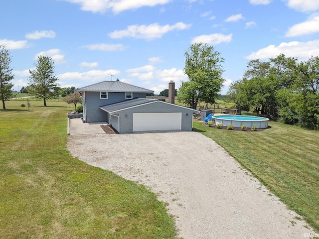 10227 E 500 S, Otterbein, IN 47970 - view of front of home featuring gravel driveway, an attached garage, and a front lawn