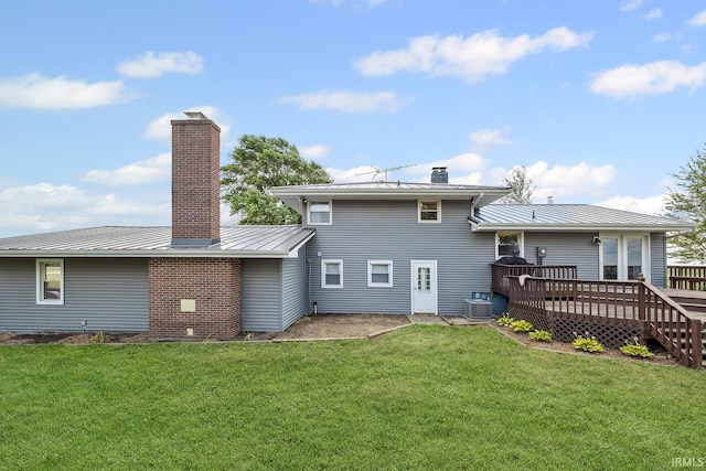 10227 E 500 S, Otterbein, IN 47970 - rear view of house featuring a chimney, a wooden deck, a lawn, and a metal roof
