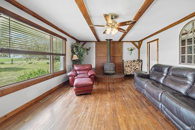 10227 E 500 S, Otterbein, IN 47970 - living area with a wood stove, hardwood / wood-style floors, ornamental molding, beamed ceiling, and a ceiling fan