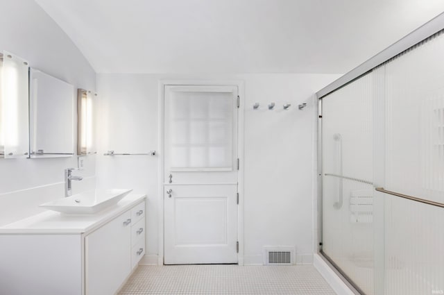 1144 N Warwick Rd, Muncie, IN 47304 - bathroom with vanity, a stall shower, tile patterned floors, and lofted ceiling