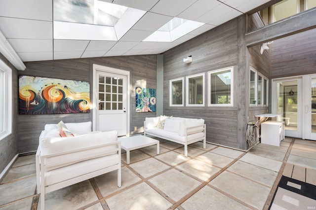 1144 N Warwick Rd, Muncie, IN 47304 - sunroom featuring wooden walls, outdoor lounge area, lofted ceiling, healthy amount of natural light, and a skylight