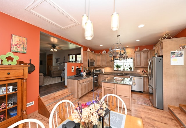 7015 W 700 N, Winamac, IN 46996 - kitchen with stainless steel appliances, light wood-style floors, a center island, hanging light fixtures, and dark stone counters