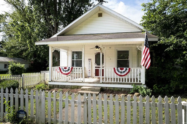113 E High St, Redkey, IN 47373 - view of front of property with a porch, ceiling fan, roof with shingles, and a fenced front yard