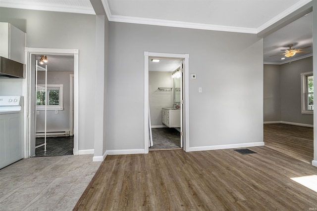 113 E High St, Redkey, IN 47373 - unfurnished bedroom featuring washer / clothes dryer, wood finished floors, a baseboard heating unit, ornamental molding, and connected bathroom