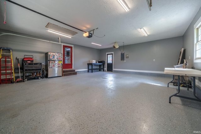 401 W Third St, Fairmount, IN 46928 - garage featuring freestanding refrigerator and a garage door opener