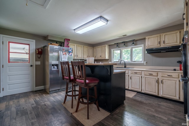 401 W Third St, Fairmount, IN 46928 - kitchen with stainless steel refrigerator with ice dispenser, under cabinet range hood, a breakfast bar area, dark wood-type flooring, and black electric cooktop