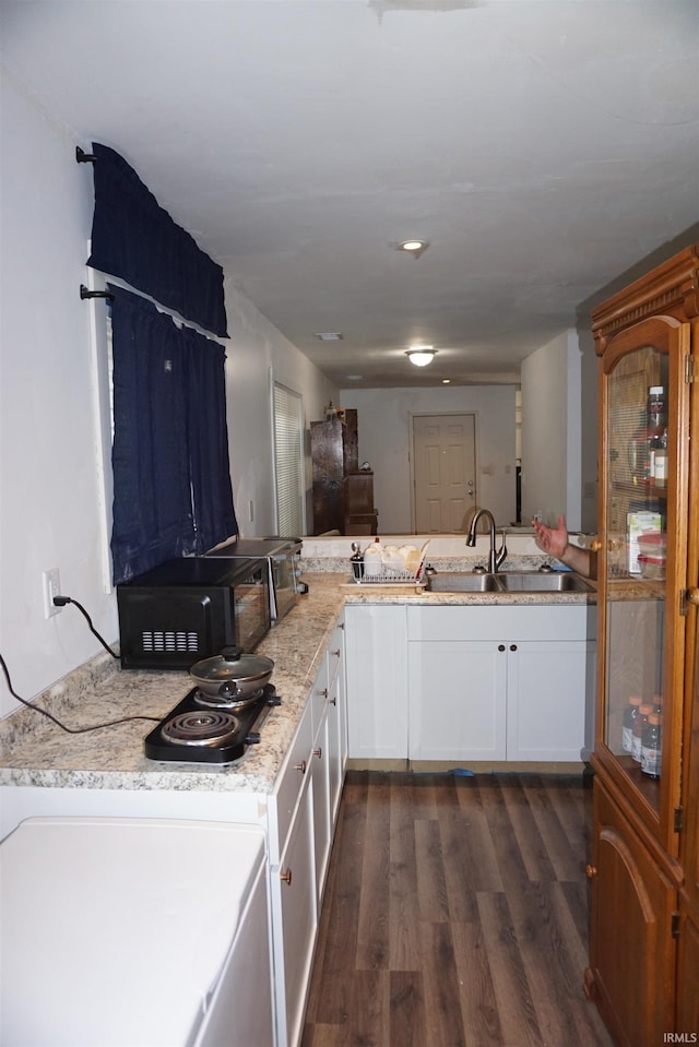 1628 E Division St, Evansville, IN 47711 - kitchen with dark wood-style floors, white cabinetry, light stone counters, and black microwave