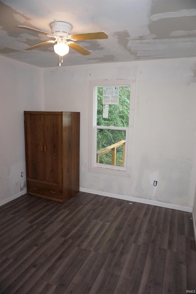 1628 E Division St, Evansville, IN 47711 - empty room with dark wood-type flooring and ceiling fan
