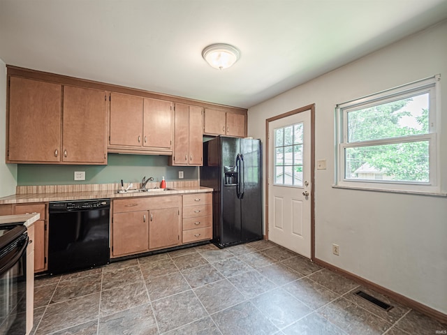 1313 Woodbine Ln, Evansville, IN 47710 - kitchen with black appliances, light countertops, and light stone finish flooring
