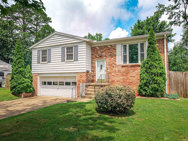 1313 Woodbine Ln, Evansville, IN 47710 - raised ranch featuring brick siding, a garage, and driveway