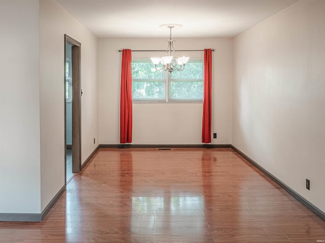 1313 Woodbine Ln, Evansville, IN 47710 - empty room with a chandelier and wood finished floors