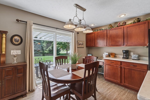 55359 Falling Water Dr, Elkhart, IN 46514 - dining area featuring light wood-type flooring and a textured ceiling