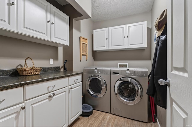 55359 Falling Water Dr, Elkhart, IN 46514 - laundry room with independent washer and dryer, light wood finished floors, cabinet space, and a textured ceiling