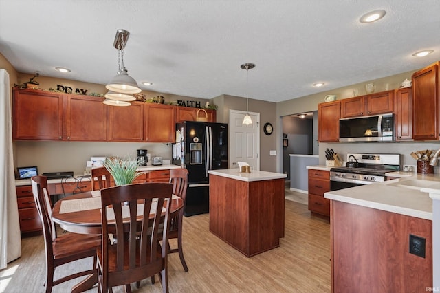 55359 Falling Water Dr, Elkhart, IN 46514 - kitchen featuring stainless steel appliances, light wood-style flooring, a kitchen island, light countertops, and recessed lighting