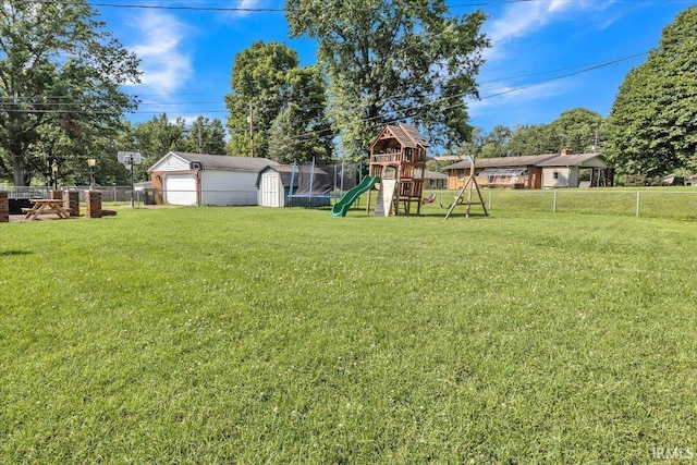 2607 Meadow Lark Ln, Evansville, IN 47720 - fenced backyard featuring a playground, a storage shed, a detached garage, and a trampoline
