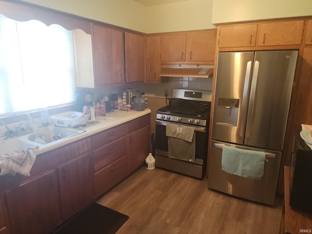 111 W Colfax St, Logansport, IN 46947 - kitchen featuring stainless steel appliances, under cabinet range hood, light countertops, and light wood-type flooring