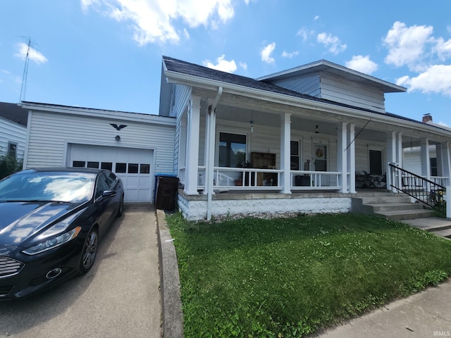 111 W Colfax St, Logansport, IN 46947 - view of front of property featuring a garage, concrete driveway, a porch, and a front yard