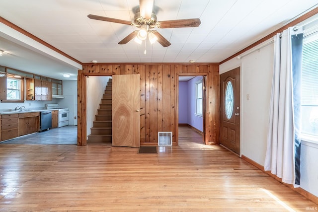 208 Chestnut St, Avilla, IN 46710 - entrance foyer featuring plenty of natural light, ceiling fan, wood walls, stairway, and light wood-style floors