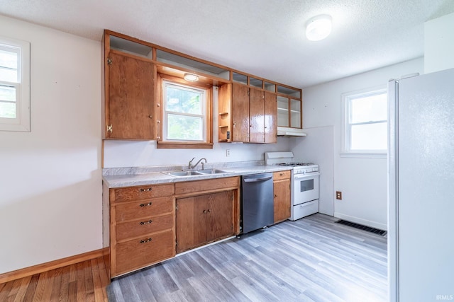 208 Chestnut St, Avilla, IN 46710 - kitchen featuring white appliances, light wood-style flooring, under cabinet range hood, light countertops, and a textured ceiling