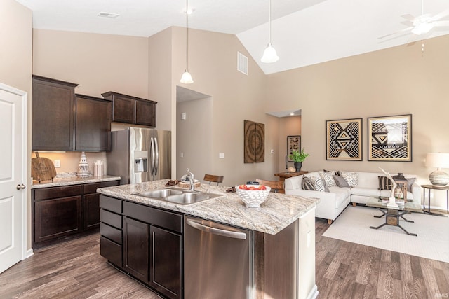 2057 Abbey Ln, Columbus, IN 47201 - kitchen featuring stainless steel appliances, high vaulted ceiling, open floor plan, dark wood-style floors, and dark brown cabinetry