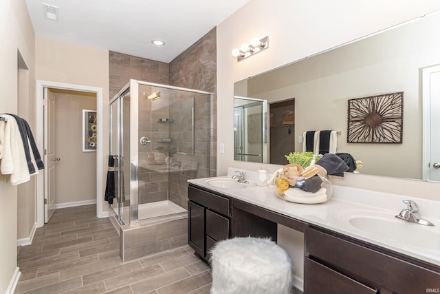 2057 Abbey Ln, Columbus, IN 47201 - full bathroom with a shower stall, double vanity, and wood finished floors