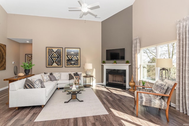 2057 Abbey Ln, Columbus, IN 47201 - living room with high vaulted ceiling, wood finished floors, ceiling fan, and a fireplace