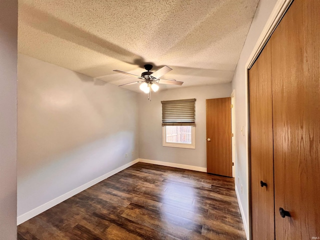 3563 County Road 40a, Auburn, IN 46706 - unfurnished bedroom with a textured ceiling, a closet, dark wood-style floors, and a ceiling fan