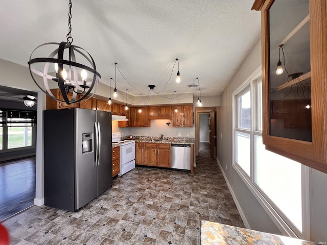 3563 County Road 40a, Auburn, IN 46706 - kitchen featuring appliances with stainless steel finishes, a chandelier, plenty of natural light, and decorative light fixtures
