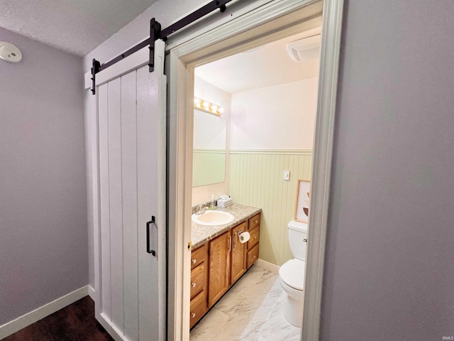 3563 County Road 40a, Auburn, IN 46706 - bathroom with vanity, marble look tiles, and wainscoting