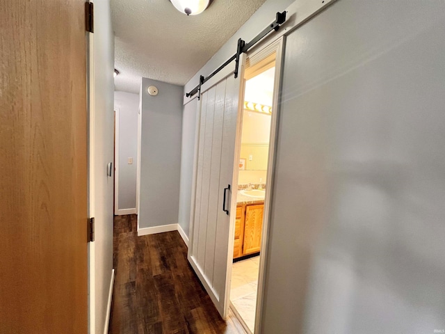3563 County Road 40a, Auburn, IN 46706 - hall featuring a barn door, a textured ceiling, and wood finished floors