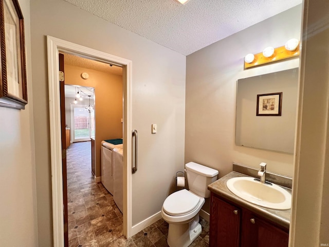 3563 County Road 40a, Auburn, IN 46706 - half bathroom featuring washer and clothes dryer, a textured ceiling, and vanity