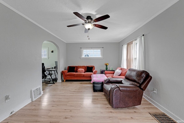 4643 Calumet Ave, Fort Wayne, IN 46806 - living room featuring ceiling fan, ornamental molding, arched walkways, and light wood-style flooring
